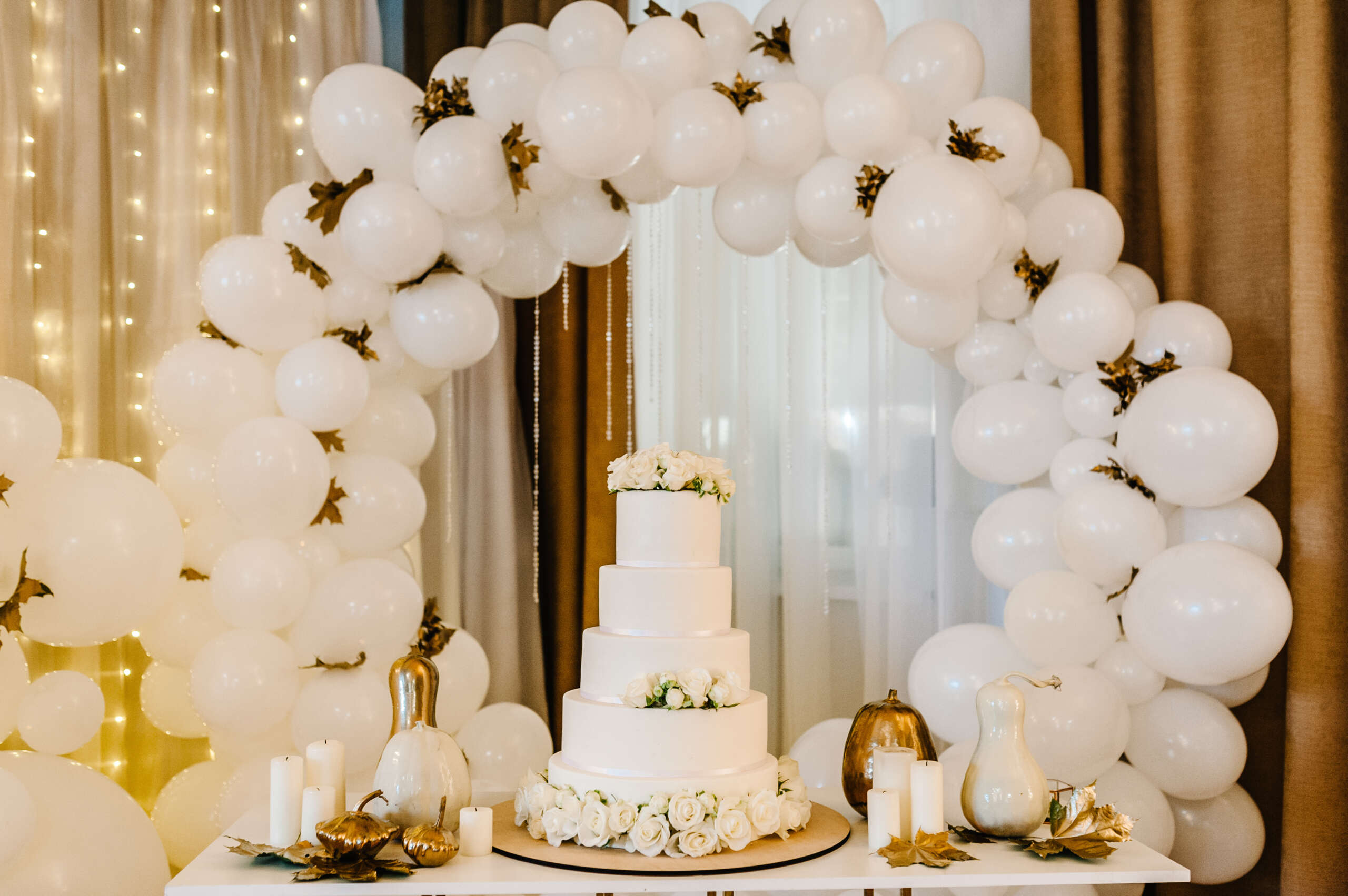 Delicious wedding reception. Cake on a background balloons. Deco