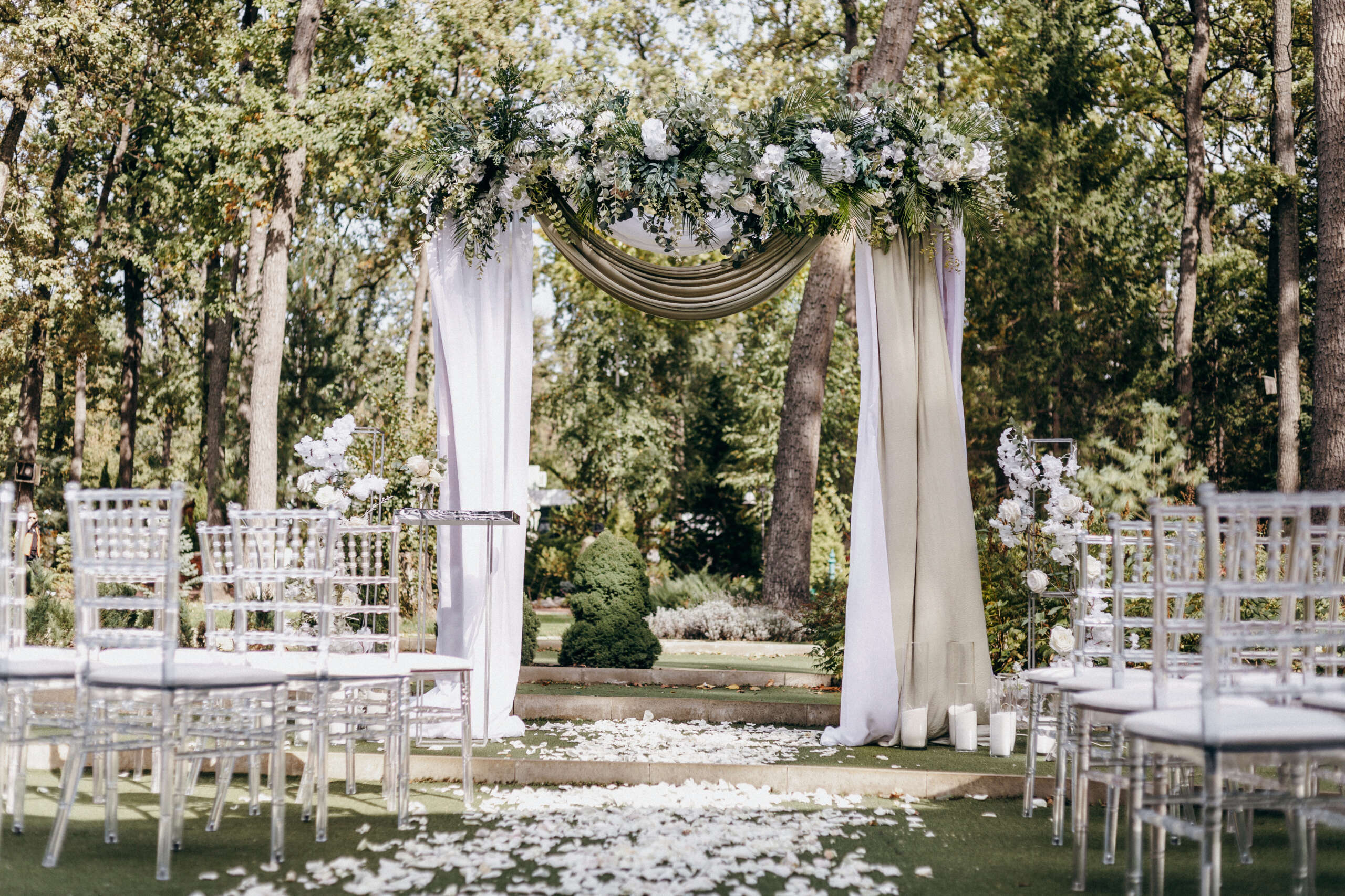 Elegant Wedding arch with fabric and flowers outdoors